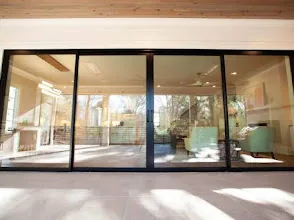 Modern dark-framed sliding door with electronic access hardware
