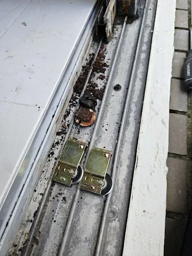 New sliding door rollers installed in a clean track