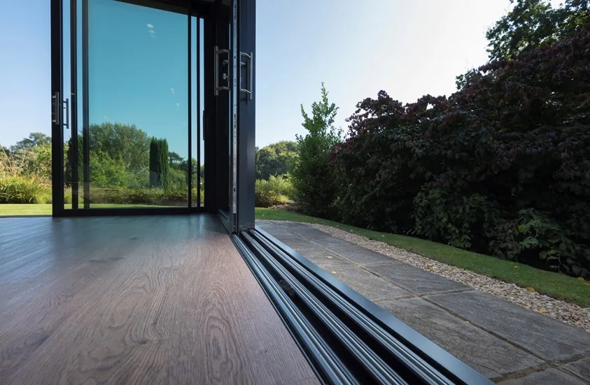 New sliding door track rails installed at a patio threshold