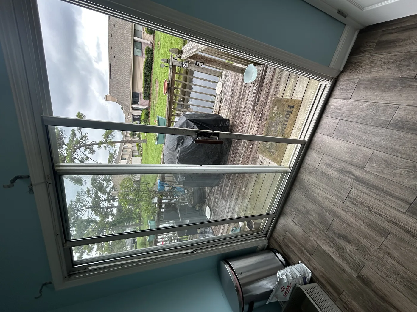 White sliding patio doors with screen door at a Palm Coast pool deck