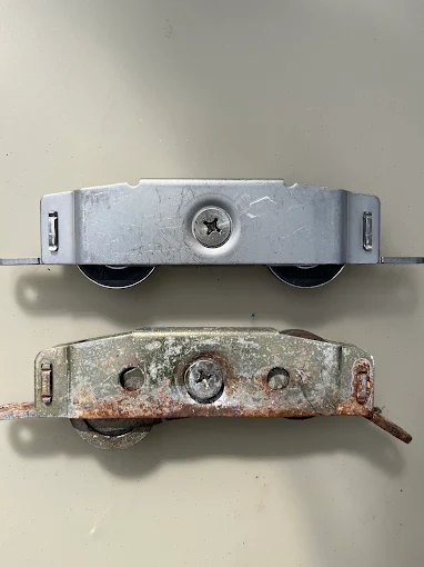 New vs. corroded sliding door roller — before and after
