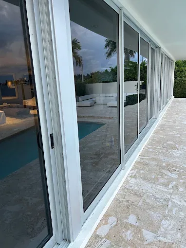 White-frame sliding glass doors at a Florida pool home in our service area